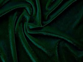 Green velvet fabric texture used as background. Empty green fabric background of soft and smooth textile material. There is space for text. photo