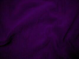 Purple clean wool fabric texture background. light natural sheep wool. Violet seamless cotton. texture of fluffy fur for designers. close-up fragment wool carpet. photo