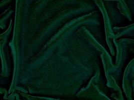 Green velvet fabric texture used as background. Empty green fabric background of soft and smooth textile material. There is space for text. photo