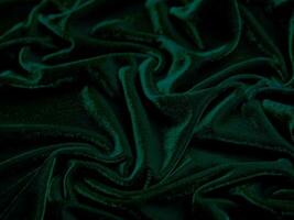 Green velvet fabric texture used as background. Empty green fabric background of soft and smooth textile material. There is space for text. photo