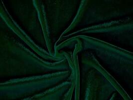 Green velvet fabric texture used as background. Empty green fabric background of soft and smooth textile material. There is space for text. photo