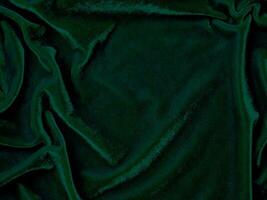 Green velvet fabric texture used as background. Empty green fabric background of soft and smooth textile material. There is space for text. photo