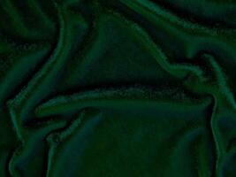 Green velvet fabric texture used as background. Empty green fabric background of soft and smooth textile material. There is space for text. photo