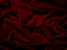 textura de tela de terciopelo rojo utilizada como fondo. fondo de tela roja vacía de material textil suave y liso. hay espacio para el texto.. foto