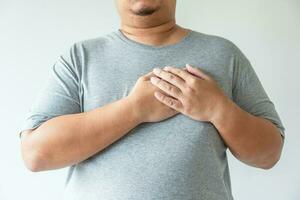 Obesity man gain overweight and fat causing to have high risk of heart attack photo