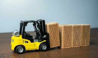 Forklift stacks wooden crates. Transportation industry. Transport department. Warehousing and logistics concept. photo