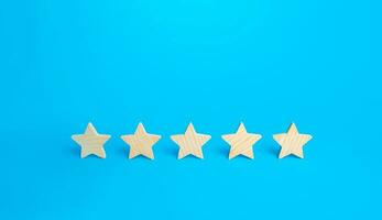 Five stars on a blue background. Rating evaluation concept. High satisfaction. Good reputation. Popularity rating of restaurants, hotels or mobile applications. Highest score. Service quality feedback photo