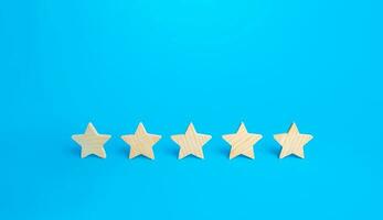 Five stars on a blue background. Rating evaluation concept. High satisfaction. Good reputation. Popularity rating of restaurants, hotels or mobile applications. Highest score. Service quality feedback photo