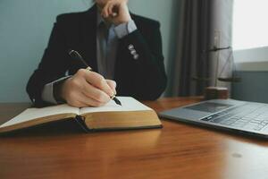 Business and lawyers discussing contract papers with brass scale on desk in office. Law, legal services, advice, justice and law concept picture with film grain effect photo