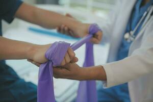 Physiotherapist working with patient in clinic, closeup photo