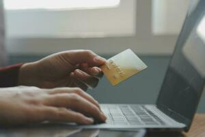 Close up of woman hand using credit card and laptop for payment and online shopping, Online shopping, payments digital banking, E-commerce concept. photo