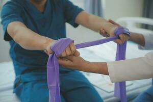 Physiotherapist working with patient in clinic, closeup photo