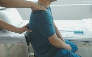 Physiotherapist working with patient in clinic, closeup photo