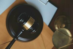 Business and lawyers discussing contract papers with brass scale on desk in office. Law, legal services, advice, justice and law concept picture with film grain effect photo