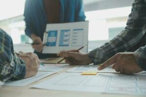 Close up ux developer and ui designer brainstorming about mobile app interface wireframe design on table with customer breif and color code at modern office.Creative digital development agency photo