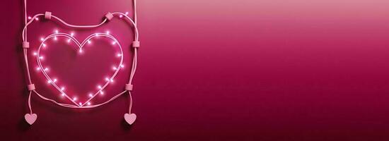Realistic Lighting Garland Forming Heart Shape On Pink Background. photo