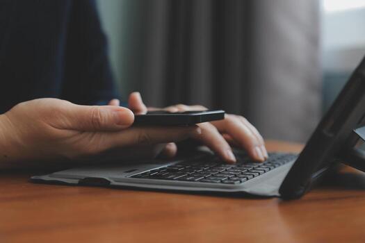 Asian Businesswoman Using laptop computer and working at office with calculator document on desk, doing planning analyzing the financial report, business plan investment, finance analysis concept. photo