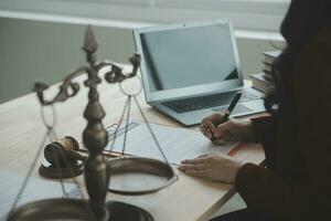 Business and lawyers discussing contract papers with brass scale on desk in office. Law, legal services, advice, justice and law concept picture with film grain effect photo