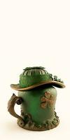 3D Render of Green And Golden Fedora Hat Covered Ancient Ethnic Pot On White Background And Copy Space.  St. Patrick's Day Concept. photo