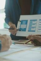 Close up ux developer and ui designer brainstorming about mobile app interface wireframe design on table with customer breif and color code at modern office.Creative digital development agency photo