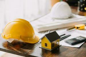 architect man working with laptop and blueprints,engineer inspection in workplace for architectural plan,sketching a construction project ,selective focus,Business concept vintage color photo