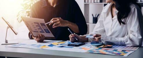Close up ux developer and ui designer brainstorming about mobile app interface wireframe design on table with customer breif and color code at modern office.Creative digital development agency photo