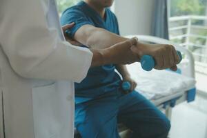 Physiotherapist working with patient in clinic, closeup photo