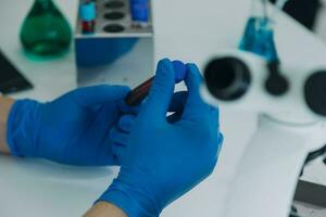 hand of scientist with test tube and flask in medical chemistry lab blue banner background photo