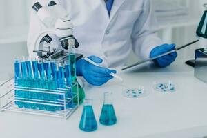 hand of scientist with test tube and flask in medical chemistry lab blue banner background photo