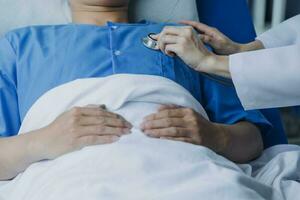 doctor check up after surgery. doctor touching patient hand and consoling. photo