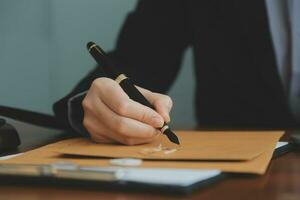 Business and lawyers discussing contract papers with brass scale on desk in office. Law, legal services, advice, justice and law concept picture with film grain effect photo