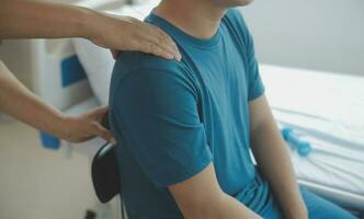 Physiotherapist working with patient in clinic, closeup photo