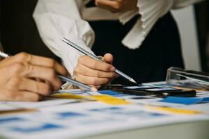 Close up ux developer and ui designer brainstorming about mobile app interface wireframe design on table with customer breif and color code at modern office.Creative digital development agency photo