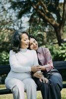 Happy senior woman enjoying in daughter's affection on Mother's day. photo