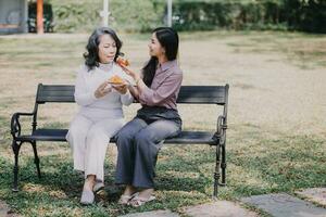 Happy senior woman enjoying in daughter's affection on Mother's day. photo