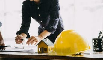 architect man working with laptop and blueprints,engineer inspection in workplace for architectural plan,sketching a construction project ,selective focus,Business concept vintage color photo