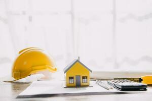 architect man working with laptop and blueprints,engineer inspection in workplace for architectural plan,sketching a construction project ,selective focus,Business concept vintage color photo