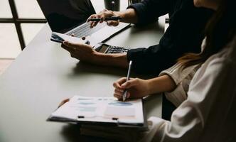 Financial Business team present. Business man hands hold documents with financial statistic stock photo, discussion, and analysis report data the charts and graphs. Finance Financial concept photo