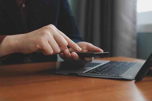 Asian Businesswoman Using laptop computer and working at office with calculator document on desk, doing planning analyzing the financial report, business plan investment, finance analysis concept. photo