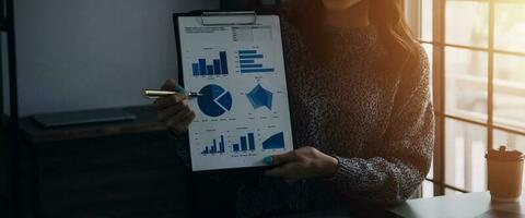 Close up of Business team analyzing income charts and graphs with modern laptop computer. Business analysis and strategy concept. photo