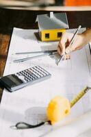 architect man working with laptop and blueprints,engineer inspection in workplace for architectural plan,sketching a construction project ,selective focus,Business concept vintage color photo