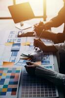 Close up ux developer and ui designer brainstorming about mobile app interface wireframe design on table with customer breif and color code at modern office.Creative digital development agency photo