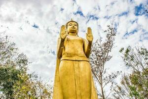 photo of standing buddha Thailand.Golden Buddha statue standing