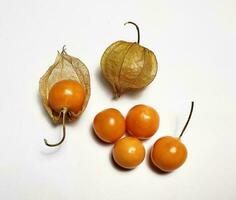 Ripe golden berry fruits, or Cape gooseberry, or Physalis isolated on white background. photo