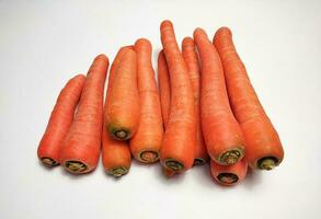 Heap of fresh carrots isolated on white background. photo