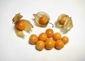 Ripe golden berry fruits, or Cape gooseberry, or Physalis isolated on white background. photo