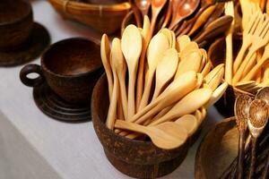 products from coconut shells A variety of designs, including teaspoons, glasses, cups, ladles, which are community products. Soft and selective focus. photo