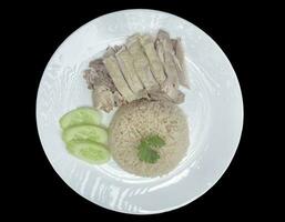 plate of rice steamed with chicken soup isolated on black background It is Thai fast food that can be found in general, delicious taste. It can be eaten by all genders and ages. photo