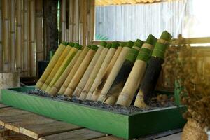 Chicken curry in a bamboo tube It is a local dish in the north of Thailand. It is a method of putting cooked food in a bamboo tube and burning it until cooked. photo