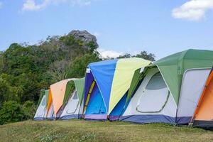 camping tent on the top of the mountain in winter in northern Thailand, view of trees, sky and clouds in clear air. Soft and selective focus. photo